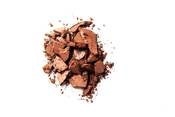 Brown eye shadow crushed samples isolated on white background. Concept of makeup and beauty.
