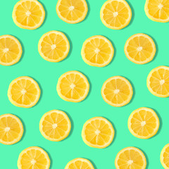 Summer fruit pattern of lemon slices on a teal background