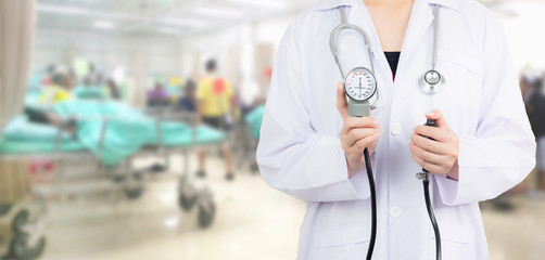 doctor holding stethoscope on blurred patient in emergency  room use  hospital background