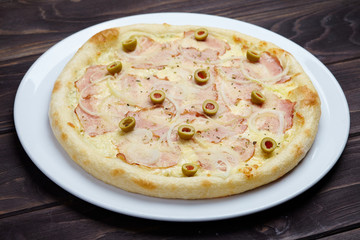 tasty pizza on the wooden background