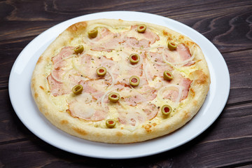 tasty pizza on the wooden background