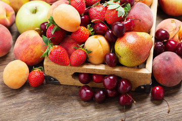 fresh ripe fruits in a wooden box