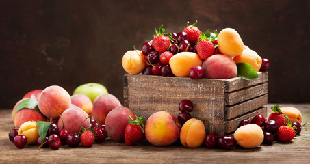 fresh ripe fruits in a wooden box