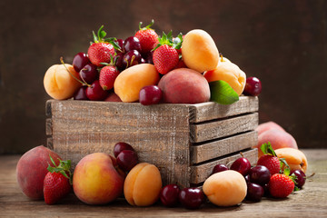 fresh ripe fruits in a wooden box