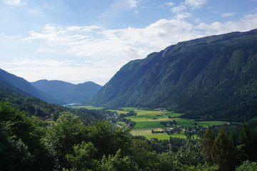 Fototapeta premium Houses in the fog on the mountainside. Tourist houses on a hill in the forest.