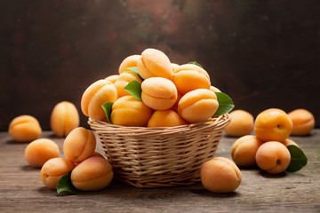 fresh ripe apricots with leaves in a basket