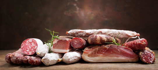 Various kind types of salami, speck and sausages - obrazy, fototapety, plakaty
