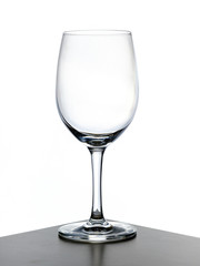 transparent wine glass with cognac being poured in
