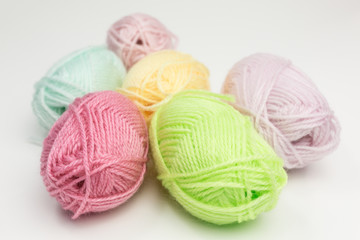 assortment of balls of wool in pastel colors