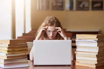 Portrait of stressed busy hard working student coping with all deadlines, being short of time,...