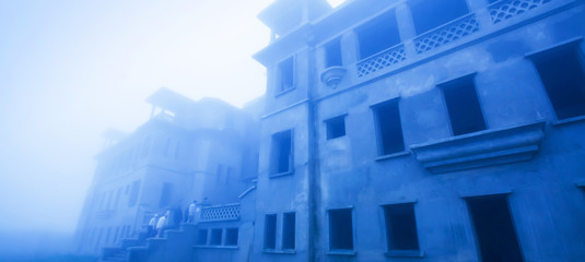 Mystic abandoned French colonial building in the mist.