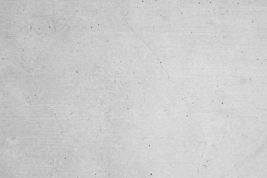Graue Betonmauer, Grauer Hintergrund, Grau Struktur mit groben und zerkratzen Stzrukturen im Indiustrial Design. Graue Steinmauer als Hintergrund und gestalterisches Element.