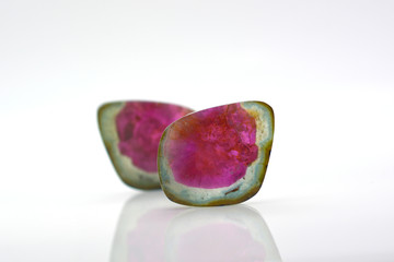 Beautiful watermelon tourmalines pink and green polished and shiny on white background