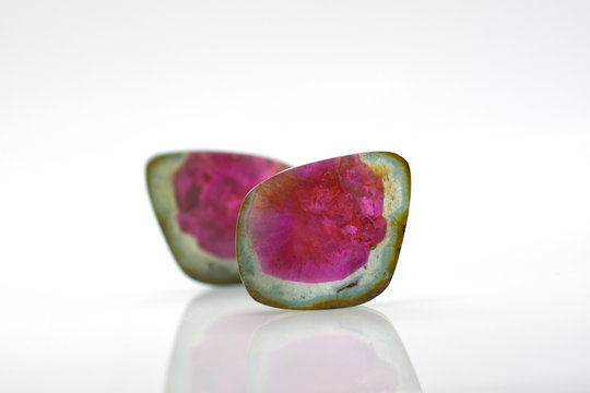 Beautiful watermelon tourmalines pink and green polished and shiny on white background