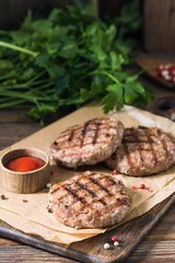 Grilled cutlets on a wooden Board on a wooden table. Rustic style