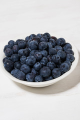 fresh farm blueberries on white background, vertical closeup
