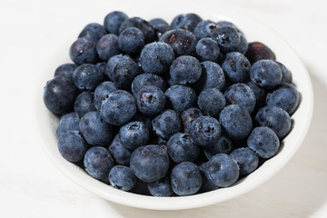 fresh farm blueberries on white background, closeup