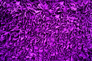 Delicate purple background silk fabric, Background texture. The purple fabric that is attached to the wooden wall has various shapes for background.