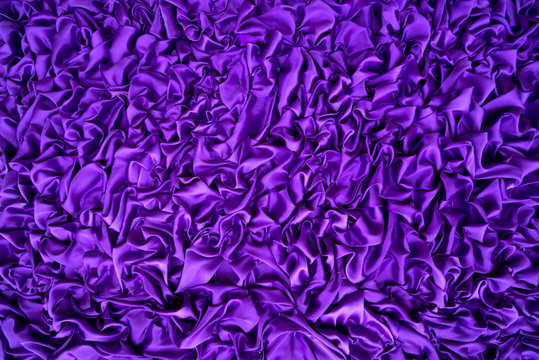 Delicate purple background silk fabric, Background texture. The purple fabric that is attached to the wooden wall has various shapes for background. © DSM