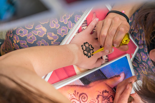 Henna tattoo close-up. Flower drawing in process.