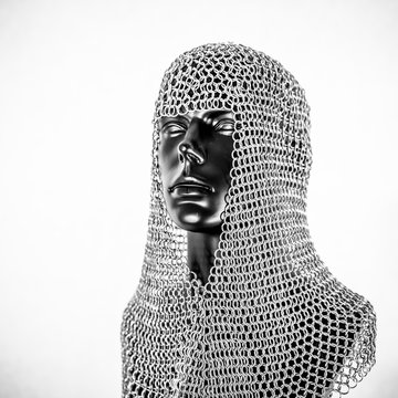 Metal, Viking helmet with chain mail in a black mannequin on white background. clothes for the viking war