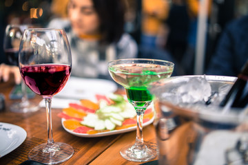 red wine on open air restaurant cafe romantic joyful young adults table