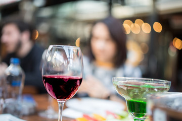 red wine on open air restaurant cafe romantic joyful young adults table