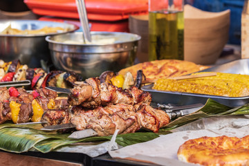 Culinary buffet with a presentation of a variety of healthy food - meat, sausage, grilled vegetables. Kitchen in the open air.