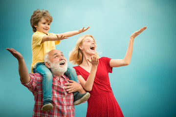 Happy child playing with toy wings arms against summer sky background. Portrait of happy...