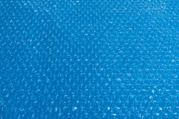 Plastic bubble film on blue background