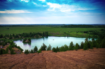 Dramatic aqua lake surrounded by sand hills landscape background