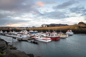 Boats in a fishing harbour in Iceland at sunset