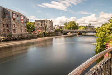 Buildings and bridge over  Corrib River with Cathedral in background