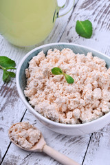 Cottage cheese of baked milk against the white wooden background