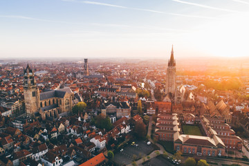 Fototapeta premium High top cityscape at sunrise. Church of Our Lady Bruges, Belgium.