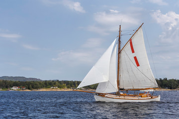 Fototapeta premium Small wooden sailboat in the sea