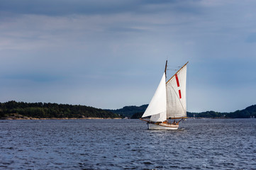 Fototapeta na wymiar Small wooden sailboat in the sea