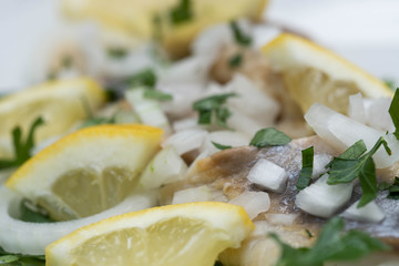 marinated herring with parsley, onion and lemon slices