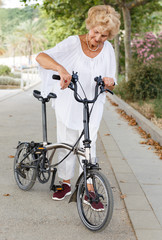 Elderly woman going to biking