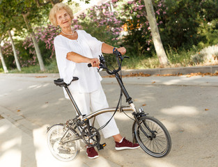 Elderly woman going to biking