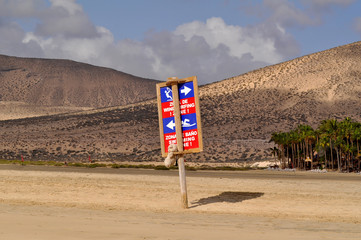 Informational sign on a sandy ocean beach Soltavento. Costa Calma, Fuerteventura, Canary Islands, Spain