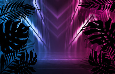 Background of empty dark scenes with neon lights and shapes, smoke. Silhouettes of tropical palm leaves in the foreground. Bright futuristic abstract background