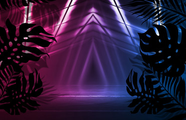 Background of empty dark scenes with neon lights and shapes, smoke. Silhouettes of tropical palm leaves in the foreground. Bright futuristic abstract background