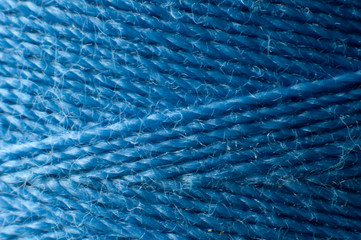 blue thread spooled up on a yarn spool