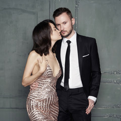 Glamour portrait of sexy young lovers. Fashionable elegant man and woman