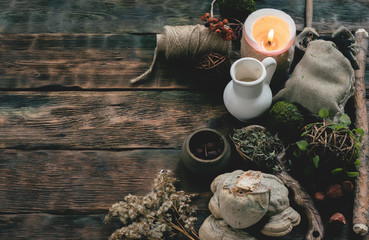 Witch doctor table with various dried ingridients above. Witchcraft concept background with copy space.