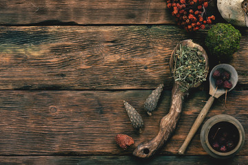 Witch doctor table with various dried ingridients above. Witchcraft concept background with copy...