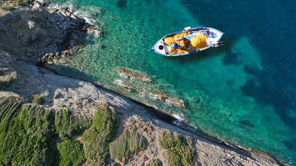 Fototapeta na wymiar Aerial top view photo of traditional fishing boat in island of Skiathos, Sporades, Greece