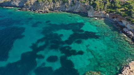 Aerial photo of tropical Caribbean bay with white sand beach and beautiful turquoise and sapphire clear sea