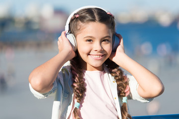 Going with the flow. Adorable headset user. Small child wearing adjustable white headset. Little...